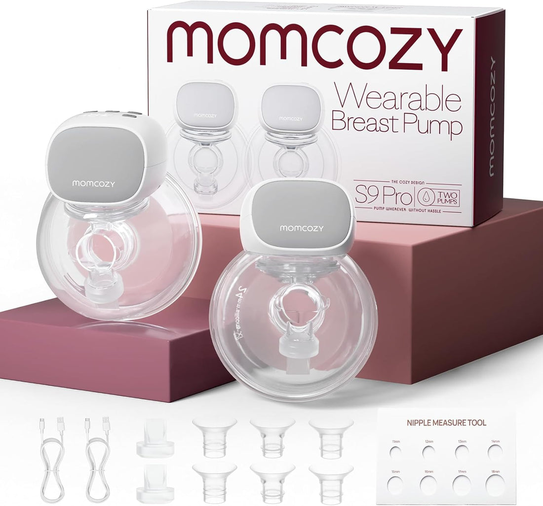 Two Momcozy S9 ProL breast pump devices with clear cups and gray tops, shown in front of their retail box. The image also includes several clear nipple tips and a nipple measurement tool.